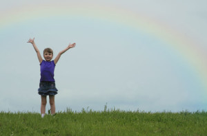 Child Praising with Rainbow
