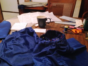 The table gets messy as I pin the inside of a sleeve to an inside-out bodice to stitch it in!